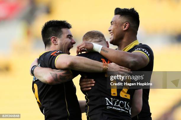 Regan Verney of Wellington celebrates after scoring a try with teammates Jackson Garden-Bachop and Julian Savea during the round two Mitre 10 Cup...