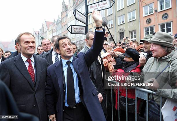 French President Nicolas Sarkozy waves to the crowd next to Poland's Prime minister Donald Tusk during a welcoming ceremony in Gdansk, northern...