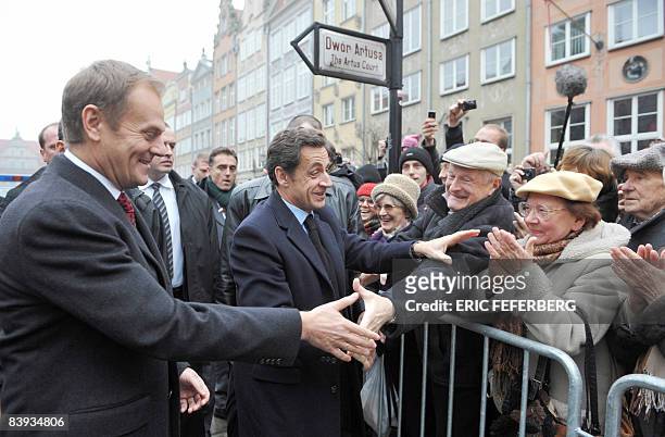 French President Nicolas Sarkozy is greeted by the crowd next to Poland's Prime minister Donald Tusk during a welcoming ceremony in Gdansk, northern...