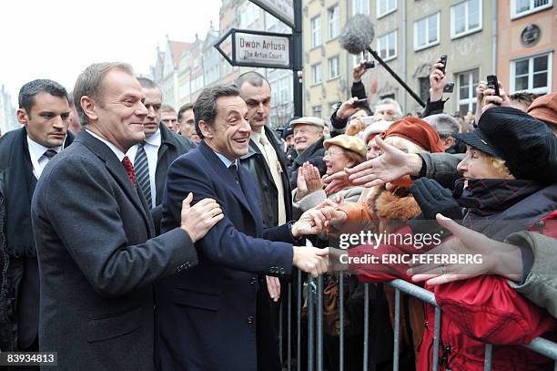 French President Nicolas Sarkozy is greeted by the crowd next to Poland's Prime minister Donald Tusk during a welcoming ceremony in Gdansk, northern...