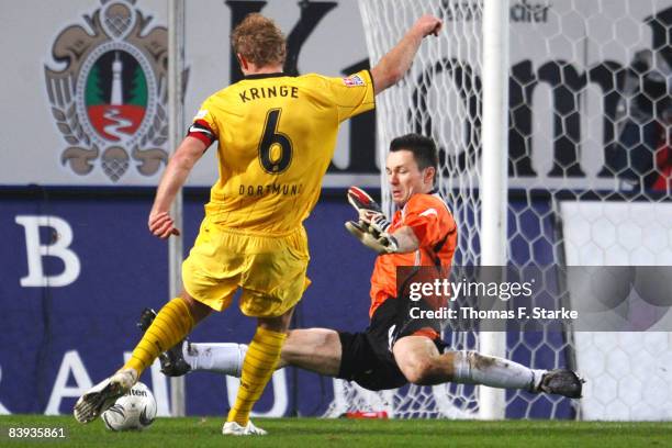 Dennis Eilhoff of Bielefeld saves a ball by Florian Kringe of Dortmund during the Bundesliga match between Arminia Bielefeld and Borussia Dortmund at...