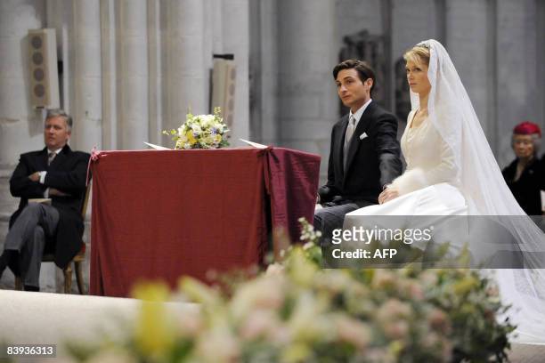 Belgium's Prince Philippe looks at Count Rodolphe of Limburg Stirum and Archduchess Maria Christina of Austria during their wedding in the...