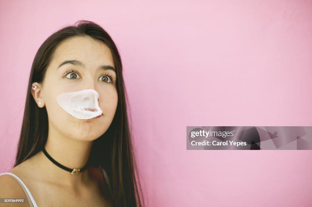 Teenager exploding bubble gum