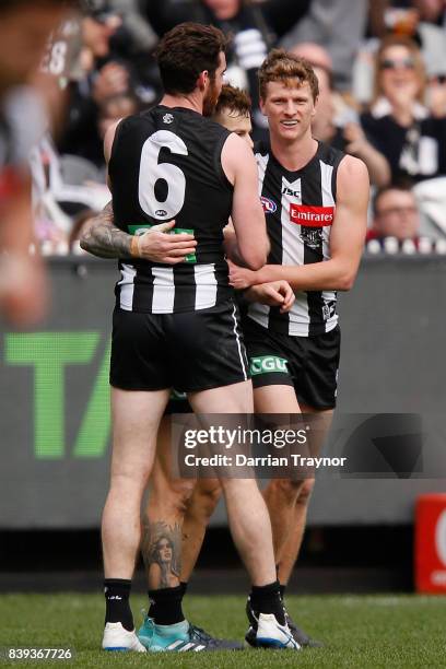 Jamie Elliott of the Magpies celebrates a goal during the round 23 AFL match between the Collingwood Magpies and the Melbourne Demons at Melbourne...