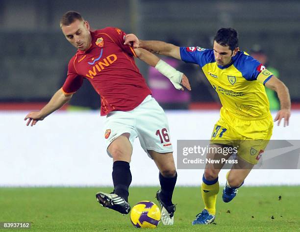 Sergio Pellissier of Chievo and Daniele de Rossi of Roma compete for the ball during the Serie A match between Chievo and Roma at the Bentegodi...