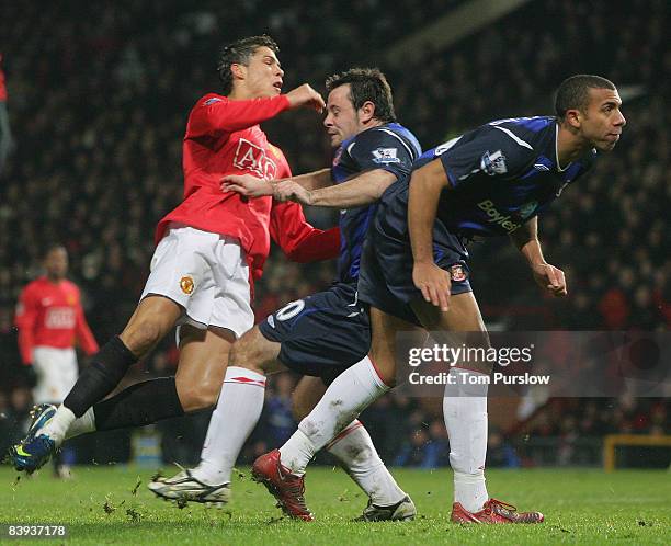 Cristiano Ronaldo of Manchester United clashes with Andy Reid of Sunderland, picking up an injury during the Barclays Premier League match between...