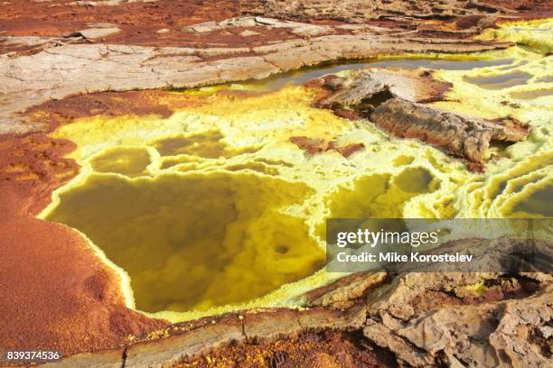 danakil depression, ethiopia - scientist and explosion stock-fotos und bilder