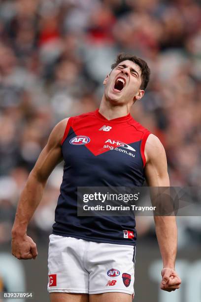 Christian Petracca of the Demons celebrates a goal during the round 23 AFL match between the Collingwood Magpies and the Melbourne Demons at...