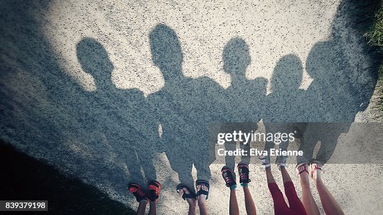 Shadows on a gravel path of a family of five Shadows on a gravel path of a family of five