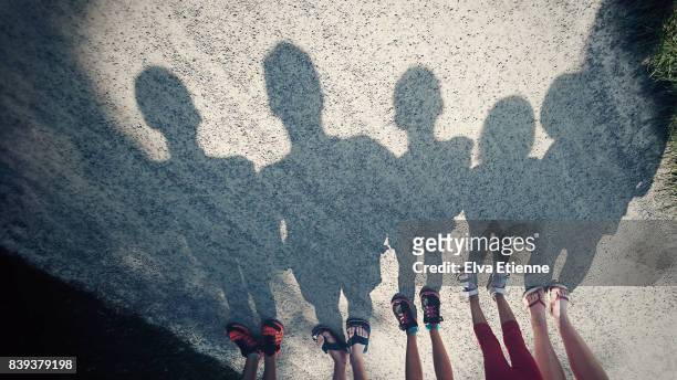 shadows on a gravel path of a family of five - group of kids stock pictures, royalty-free photos & images