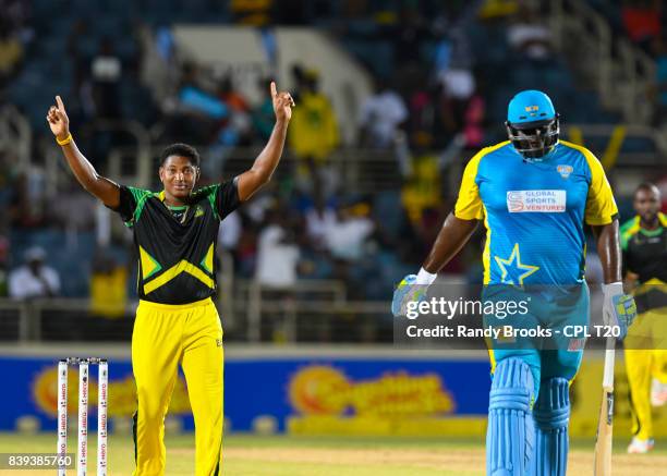 In this handout image provided by CPL T20, Krishmar Santokie of Jamaica Tallawahs celebrates the dismissal of Rahkeem Cornwall of St Lucia Stars...