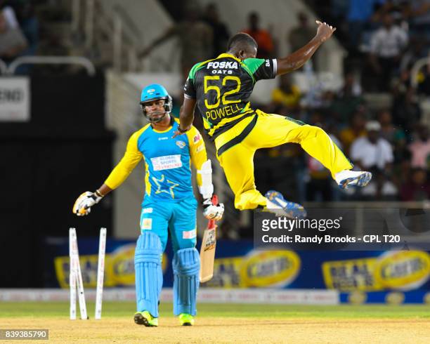 In this handout image provided by CPL T20, Rovman Powell of Jamaica Tallawahs celebrate the dismissal of Marlon Samuels of St Lucia Stars during...