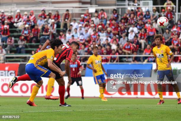 Reis of Consadole Sapporo heads the ball to score the opening goal during the J.League J1 match between Consadole Sapporo and Vegalta Sendai at...