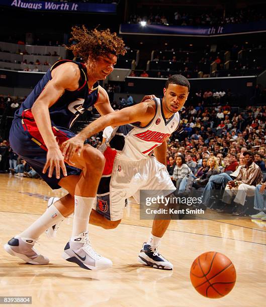 Augustin of the Charlotte Bobcats goes for the steal against Anderson Varejao of the Cleveland Cavaliers on December 06, 2008 at the Time Warner...