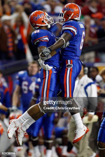 Louis Murphy and Deonte Thompson of the Florida Gators celebrate after a touchdown against the Alabama Crimson Tide during the SEC Championship on...