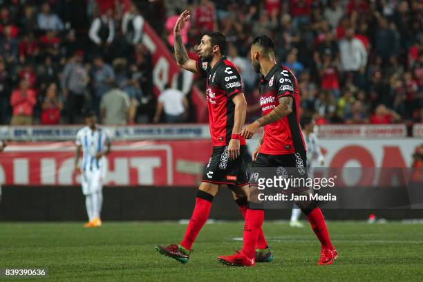 Alejandro Donatti and Victor Aguilera of Tijuana celebrate the first goal of his team scored by his teammate Gustavo Bou during the seventh round...