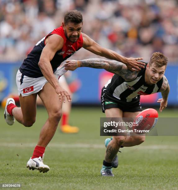 Neville Jetta of the Demons and Jamie Elliott of the Magpies compete for the ball during the round 23 AFL match between the Collingwood Magpies and...