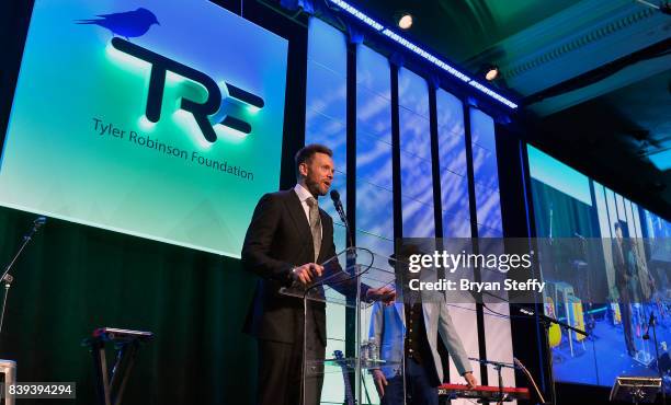 Actor/comedian Joel McHale introduces bassist Ben Mckee of Imagine Dragons during the Tyler Robinson Foundation's 4th annual 'Believer Gala' at...