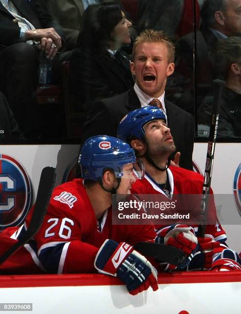 Injured player Mike Komisarek of the Montreal Canadiens yells from the bench while facing the New Jersey Devils during their NHL game at the Bell...