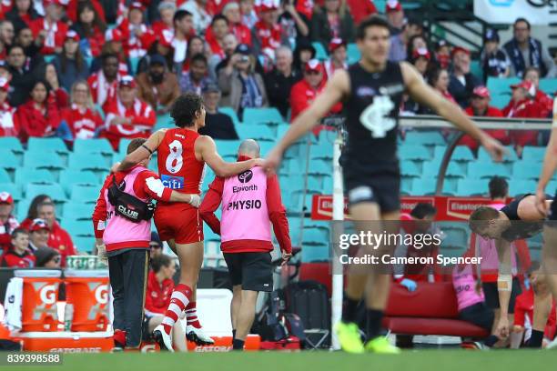 Kurt Tippett of the Swans leaves the field injured during the round 23 AFL match between the Sydney Swans and the Carlton Blues at Sydney Cricket...