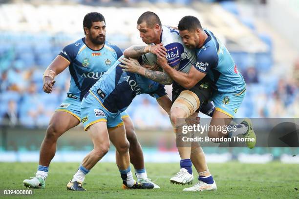 David Klemmer of the Bulldogs is tackled by the Titans defence during the round 25 NRL match between the Gold Coast Titans and the Canterbury...