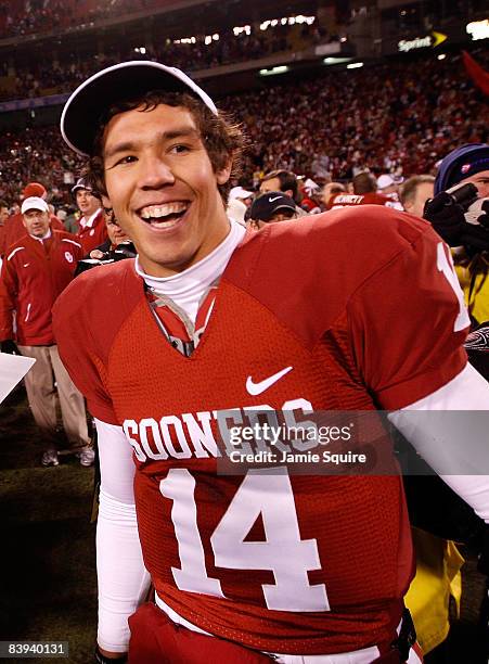 Quarterback Sam Bradford of the Oklahoma Sooners celebrates after the Sooners defeated the Missouri Tigers to win the Big 12 Championship game on...