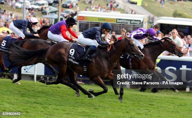 Jockey Mickael Barzalona goes on to win the Investec Derby on Pour Moi during the Investec Derby Festival, at Epsom Downs Racecourse.