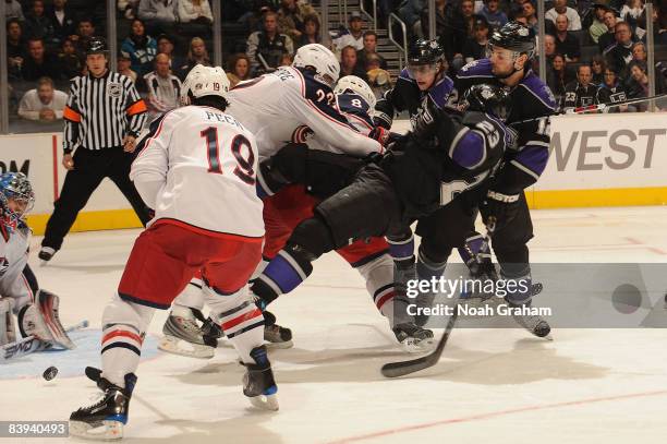 Dustin Brown of the Los Angeles Kings collides with Mike Commodore and Jan Hejda of the Columbus Blue Jackets during the game on December 6, 2008 at...