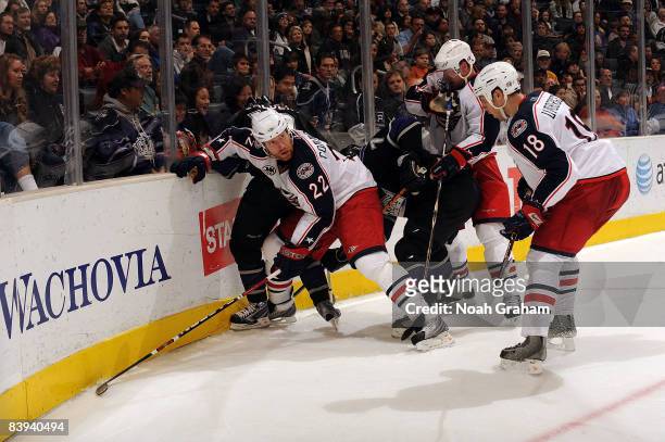 Mike Commodore and R.J. Umberger of the Columbus Blue Jackets battle alongside the boards for the puck against the Los Angeles Kings during the game...