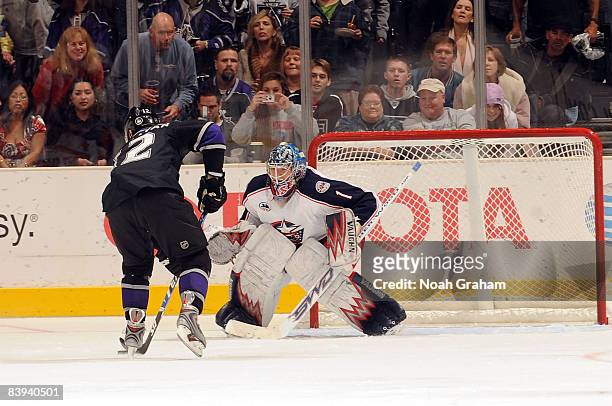 Steve Mason of the Columbus Blue Jackets defends the net as Patrick O'Sullivan of the Los Angeles Kings attempts to makes his first NHL career...