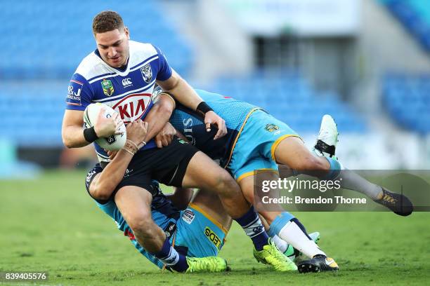 Brenko Lee of the Bulldogs is tackled by the Titans defence during the round 25 NRL match between the Gold Coast Titans and the Canterbury Bulldogs...