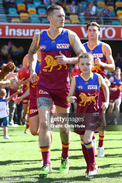 Dayne Beams leads the Lions out for the round 23 AFL match between the Brisbane Lions and the North Melbourne Kangaroos at The Gabba on August 26,...