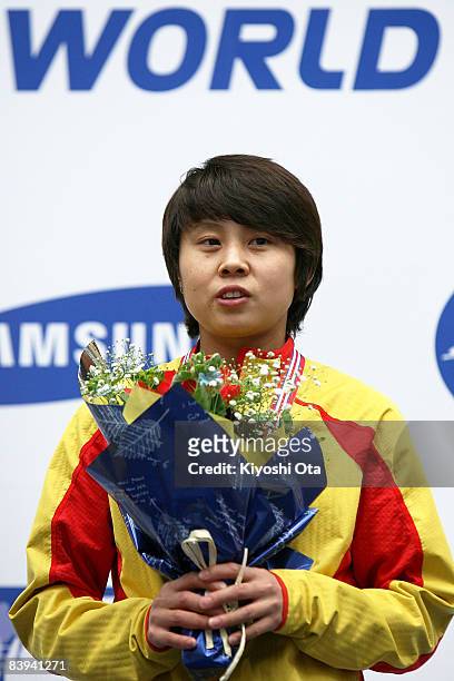 Gold medalist Wang Meng of China celebrates on the podium at the award ceremony after the Ladies 500m final during the Samsung ISU World Cup Short...