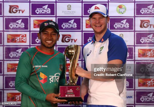 Mushfiqur Rahim of Bangladesh and Steve Smith of Australia pose with the series trophy during a press conference prior to an Australian Test team...