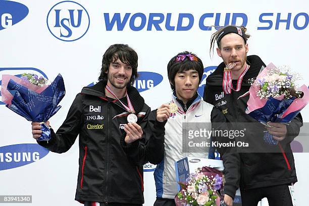 Silver medalist Charles Hamelin of Canada, gold medalist Lee Ho-suk of South Korea and bronze medalist Olivier Jean of Canada pose for photographers...