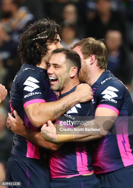 Cameron Smith of the Storm is congratulated by his teammates after scoring a try during the round 25 NRL match between the Melbourne Storm and the...