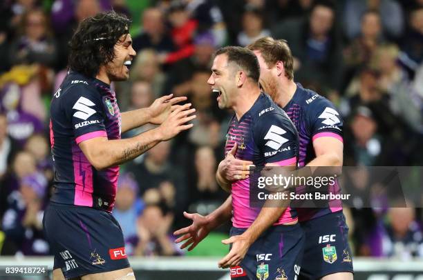 Cameron Smith of the Storm is congratulated by his teammates after scoring a try during the round 25 NRL match between the Melbourne Storm and the...