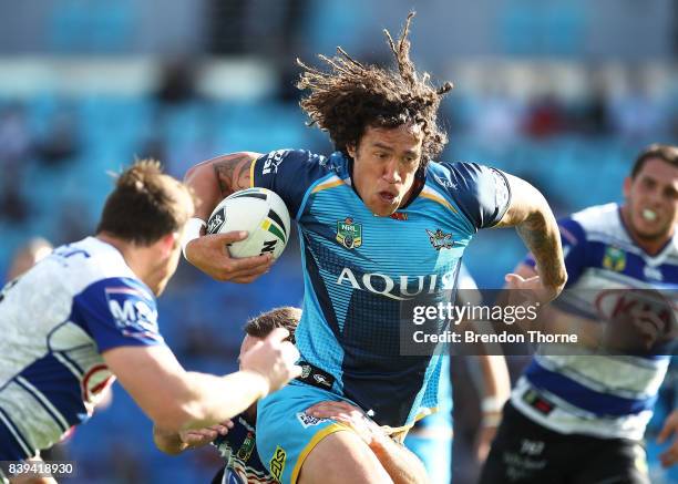 Kevin Proctor of the Titans runs the ball during the round 25 NRL match between the Gold Coast Titans and the Canterbury Bulldogs at Cbus Super...