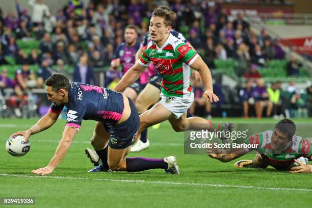 Billy Slater of the Storm runs in to score a try during the round 25 NRL match between the Melbourne Storm and the South Sydney Rabbitohs at AAMI...