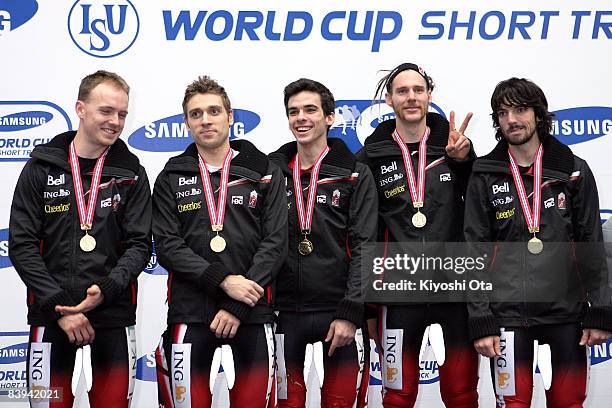 Members of the Canadian team celebrate with their gold medals on the podium at the award ceremony after the Men's 5000m Relay final during the...