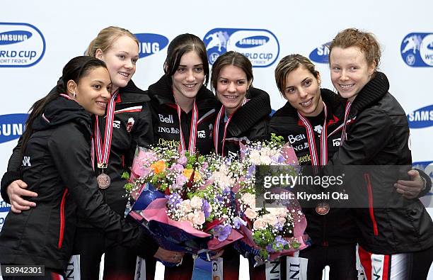 Members of the Canadian team celebrate their bronze medals at the award ceremony after the Ladies 3000m Relay final during the Samsung ISU World Cup...