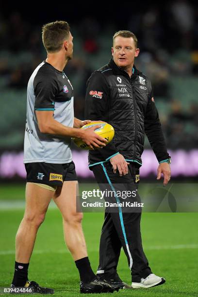 Michael Voss Midfield Manager chats with Dan Houston of the Power prior to the round 23 AFL match between the Port Adelaide Power and the Gold Coast...