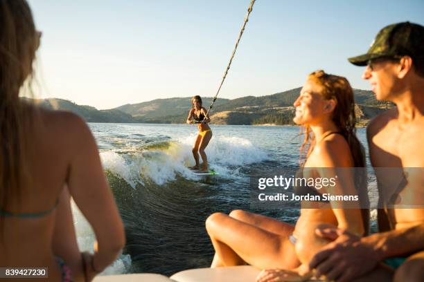 a group of freinds enjoying a day at the lake - extreme depth of field stock pictures, royalty-free photos & images