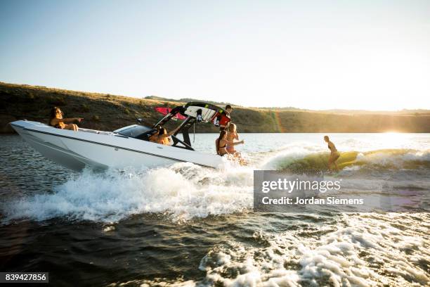 a group of freinds enjoying a day at the lake - waterskiing stock pictures, royalty-free photos & images