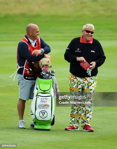 John Daly of the United States shares a joke with caddie Simon Hurd on the 3rd hole during day three of the Made in Denmark at Himmerland Golf & Spa...