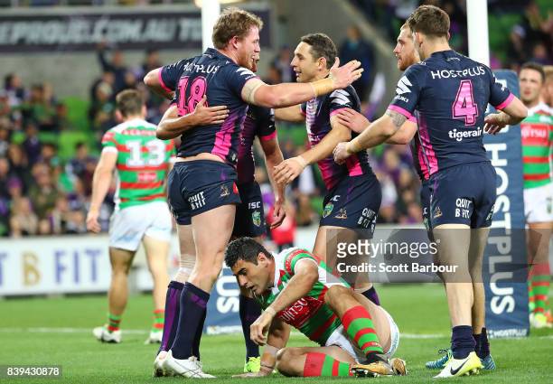Tim Glasby of the Storm celebrates with his teammates after scoring a try during the round 25 NRL match between the Melbourne Storm and the South...