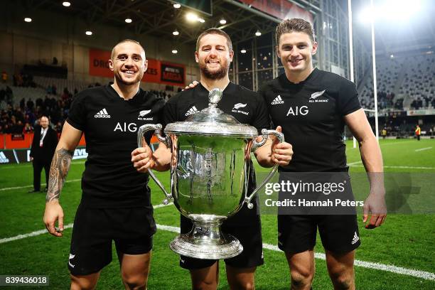 Perenara, Dane Coles and Beauden Barrett of the All Blacks celebrate with the Bledisloe Cup after winning The Rugby Championship Bledisloe Cup match...