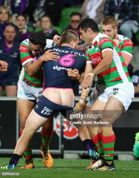 Cameron Munster of the Storm is tackled during the round 25 NRL match between the Melbourne Storm and the South Sydney Rabbitohs at AAMI Park on...