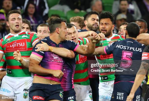 Will Chambers and Josh Addo-Carr of the Storm fight after Sam Burgess of the Rabbitohs was put on report for a tackle on Felise Kaufusi during the...