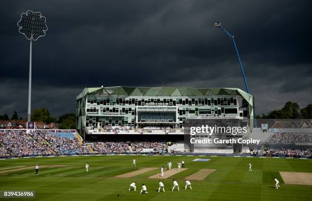 Dark clouds as Stuart Broad of England runs into bowl during day two of the 2nd Investec Test between England and the West Indies at Headingley on...